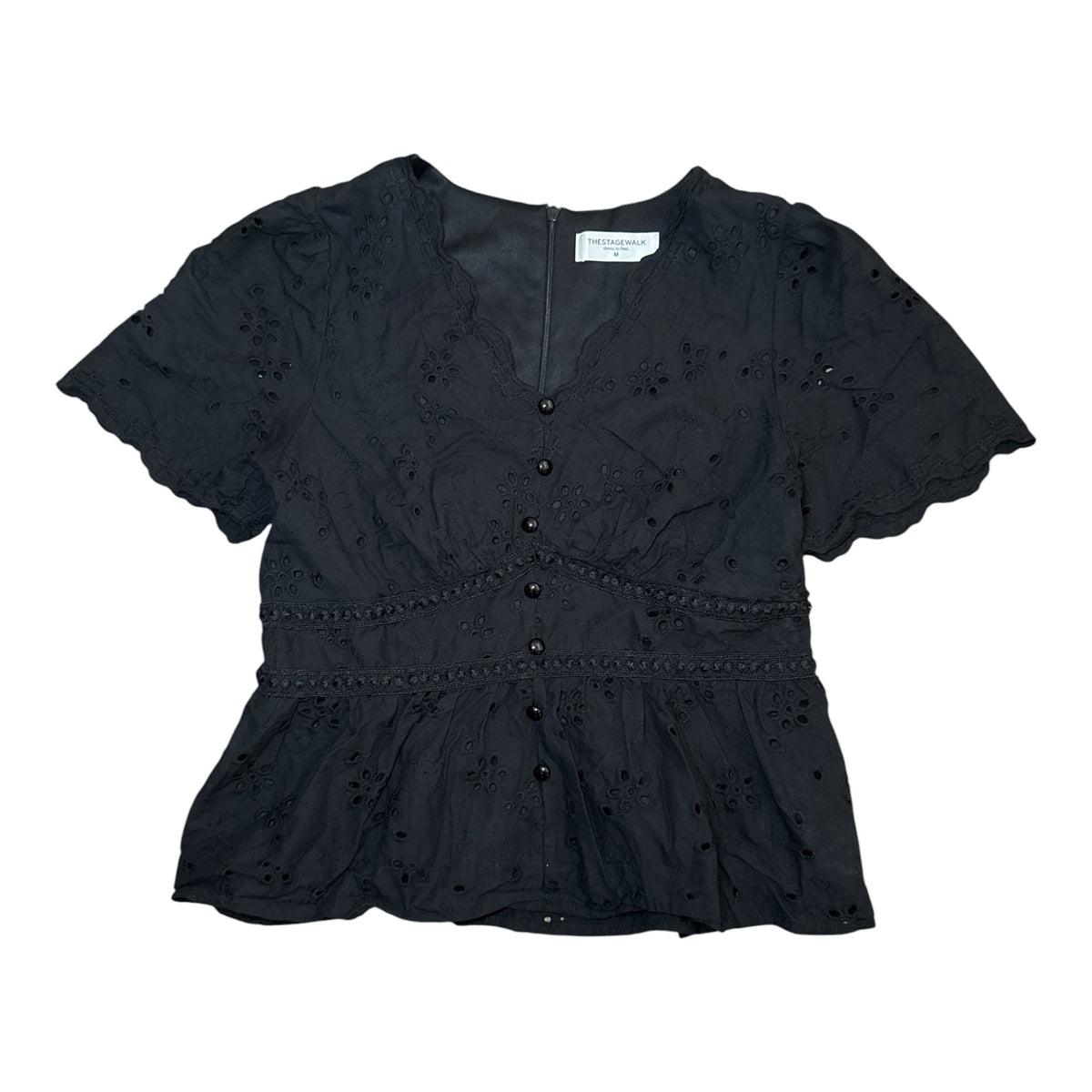 Gemstoresg black eyelet peplum blouse with V-neck, button-down front, and short puff sleeves with scalloped edges.