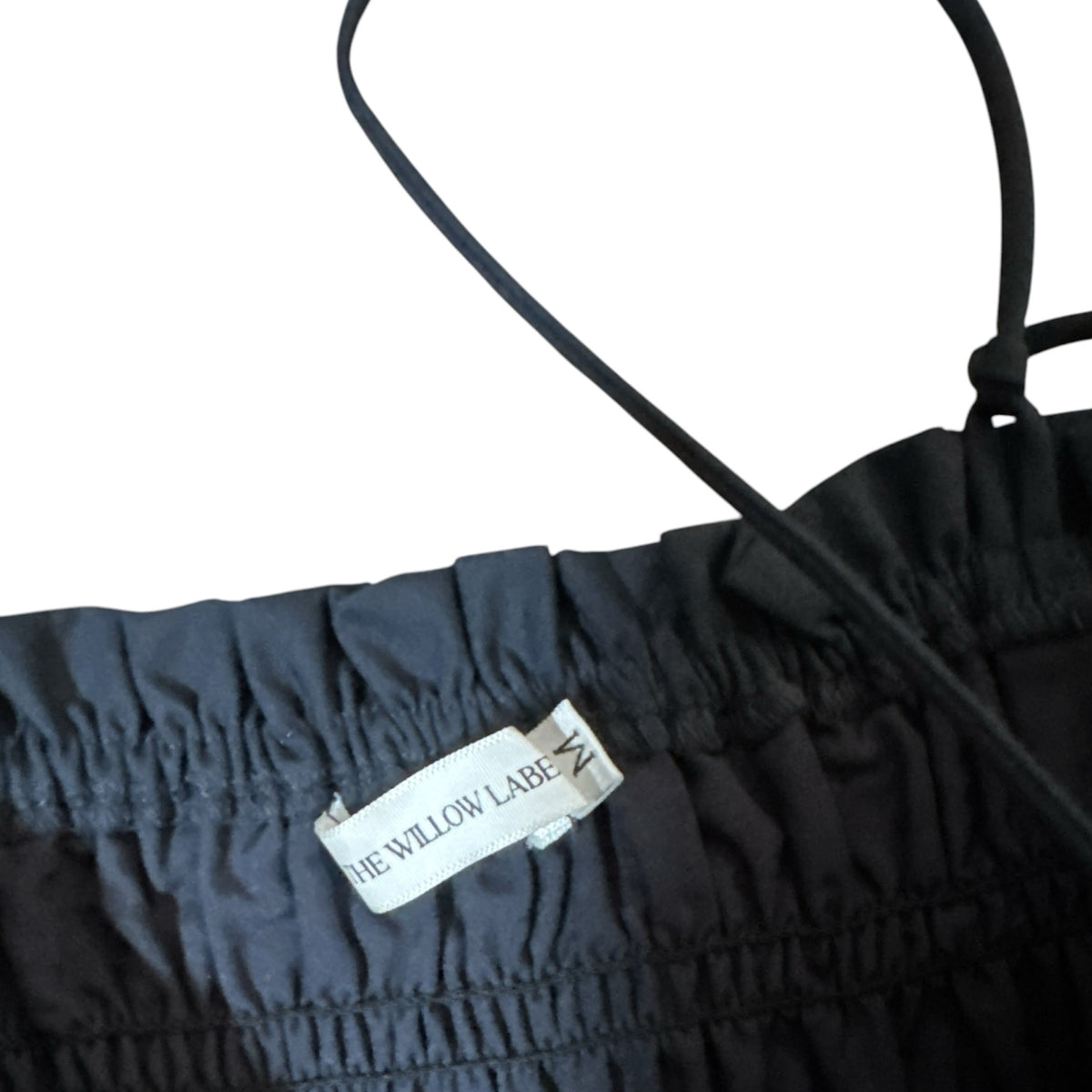 Gemstoresg black smocked peplum camisole with spaghetti straps and The Willow Label brand tag