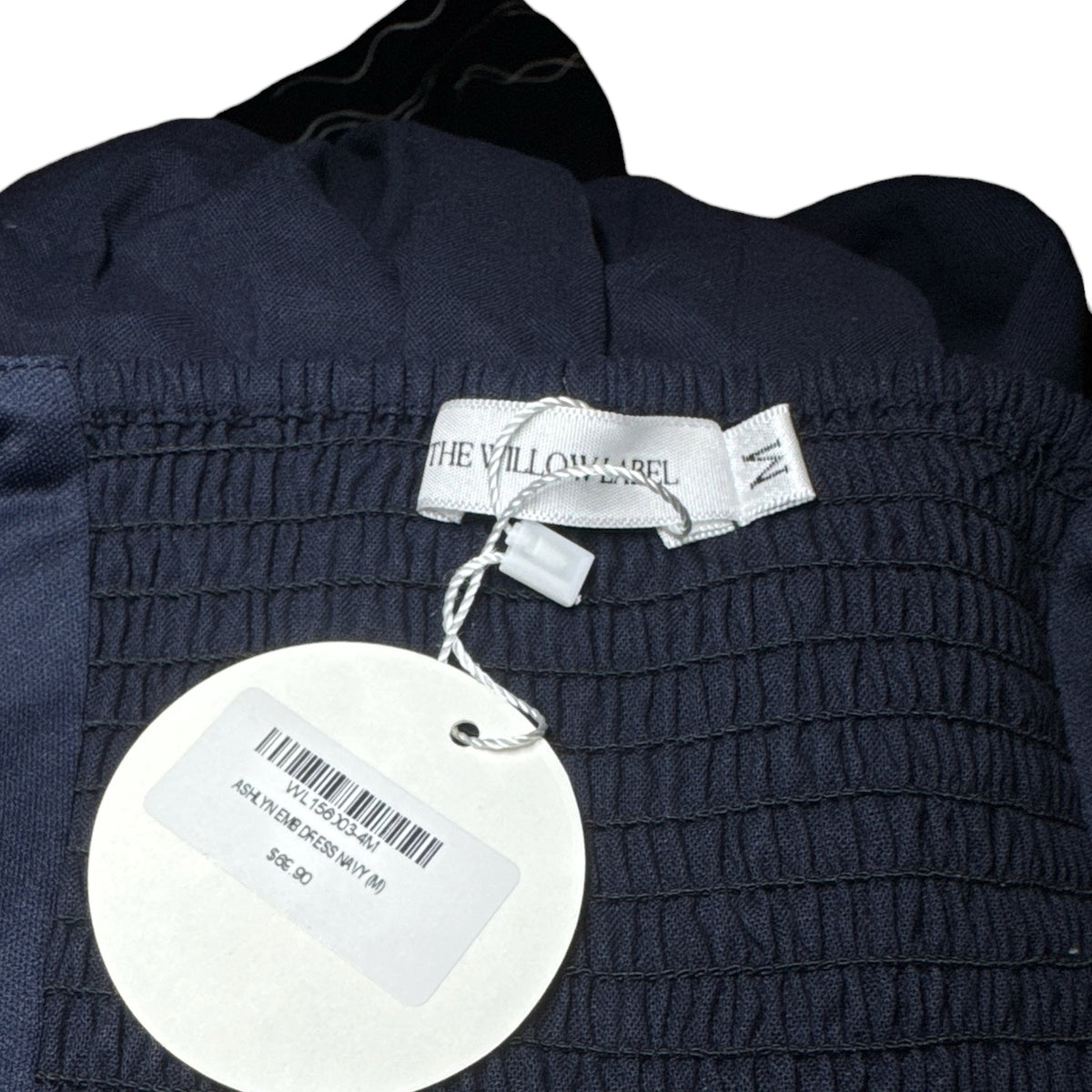 Gemstoresg navy midi dress featuring a smocked bodice with The Willow Label brand tag and product price swing tag