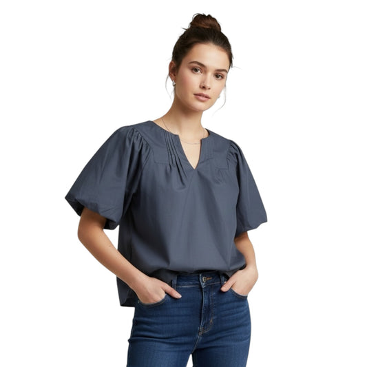 Gemstoresg slate blue cotton blouse with puff sleeves, pleated neckline, and V-neck, worn by a model with jeans.